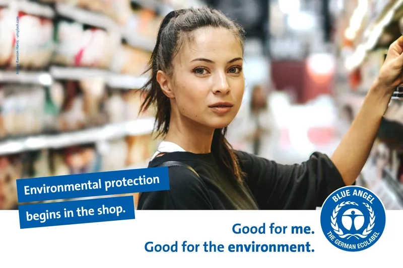 Young woman in the supermarket. Slogan: Environmental protection begins in the shop.
