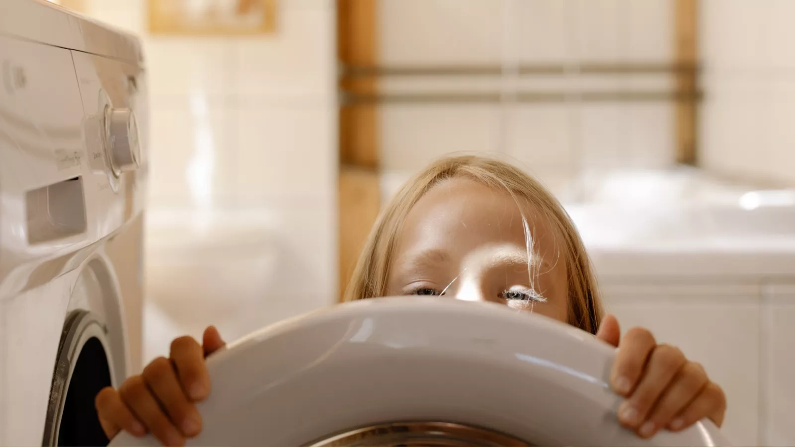 Girl behind the washing machine flap